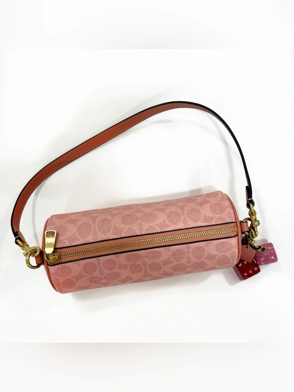 New Coach cylinder barrel bag in melon pink/ brass with signature canvas